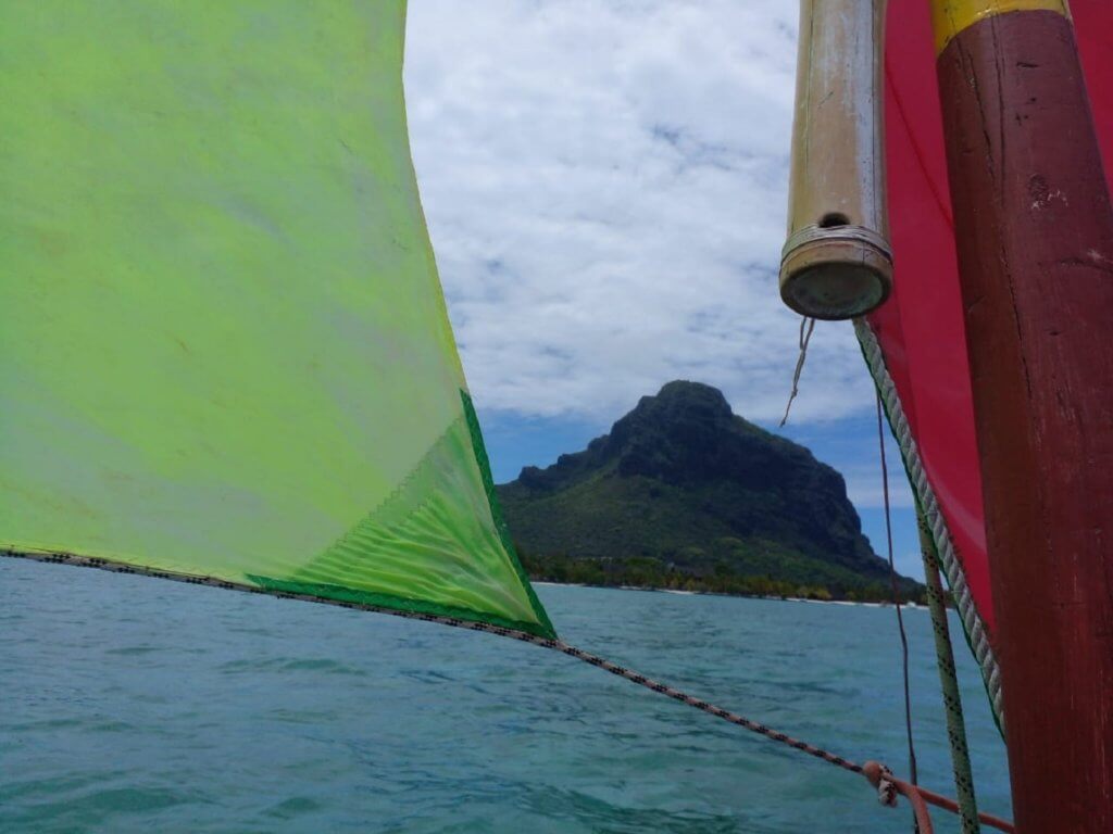 Mast and boomless loose footed triangular mainsail Leg of mutton spritsail sprit pirogue Christopher sailing school Mauritius