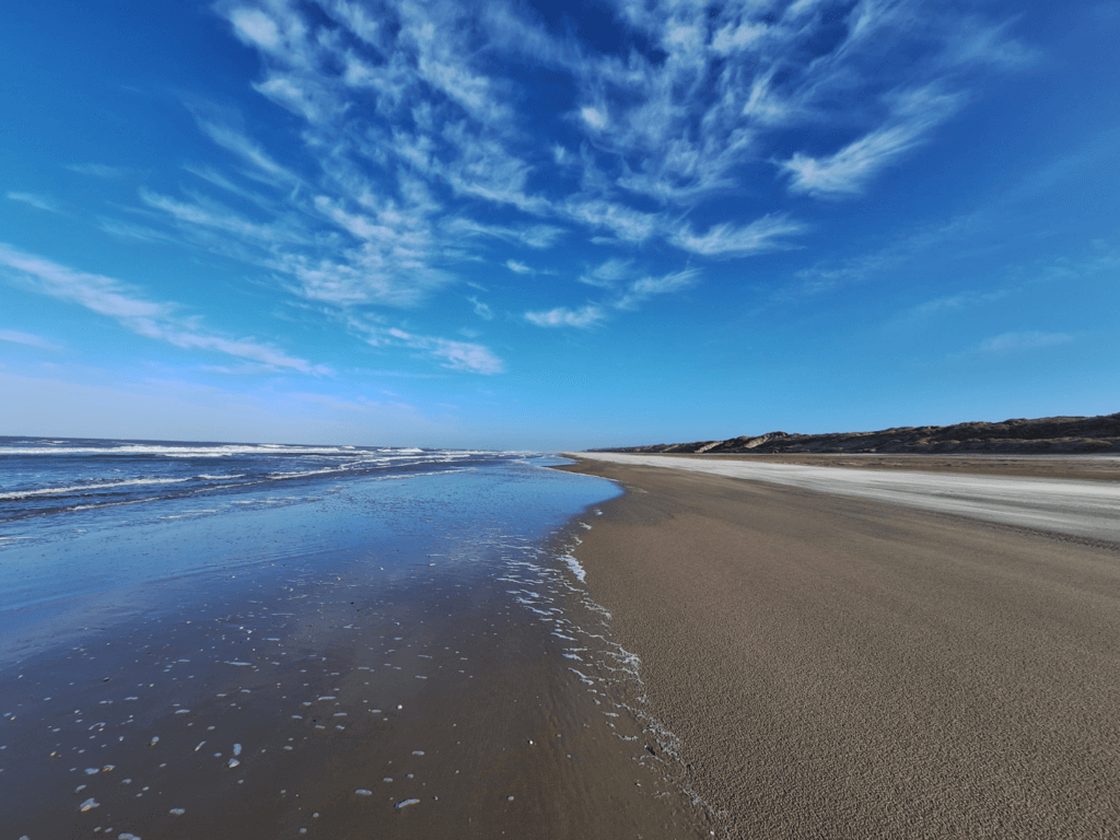 sunny winter day Dutch beach the Netherlands Vlieland blue sky reflections