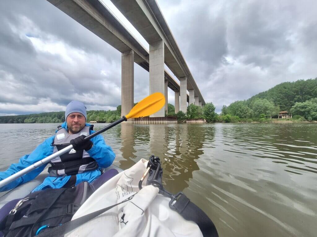 Jonas kayaking under Beska Bridge Serbia Vojvodina longest bridge Danube river inflatable kayak