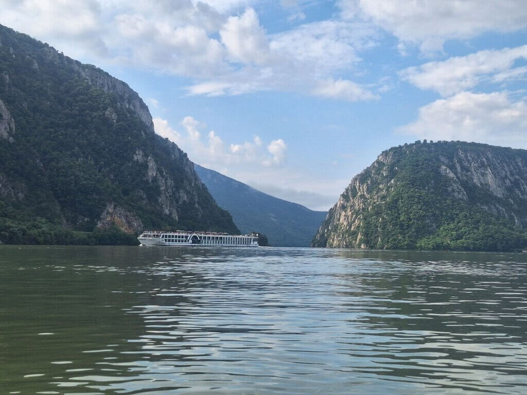 Danube River looking at Great Kazan Gorge Veliki Kazan Klisura Cazanele Mari canyon cruise ship narrow kayaking traffic ships