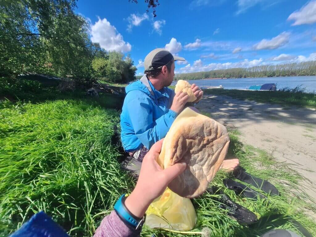 eating a sandwich while waiting for a pickup inflatable kayak Erdut Croatia