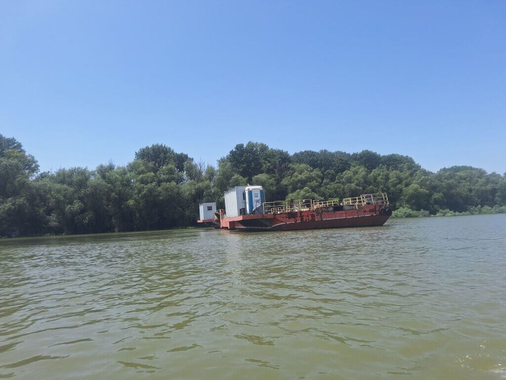 half sunken barge with a eko toi toilet portapotty Danube River Svishtov Bulgaria