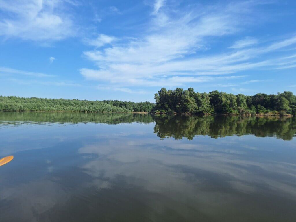 Danube River kayaking near Seimeni Romania reflections water forest river island Ostrovul Nou