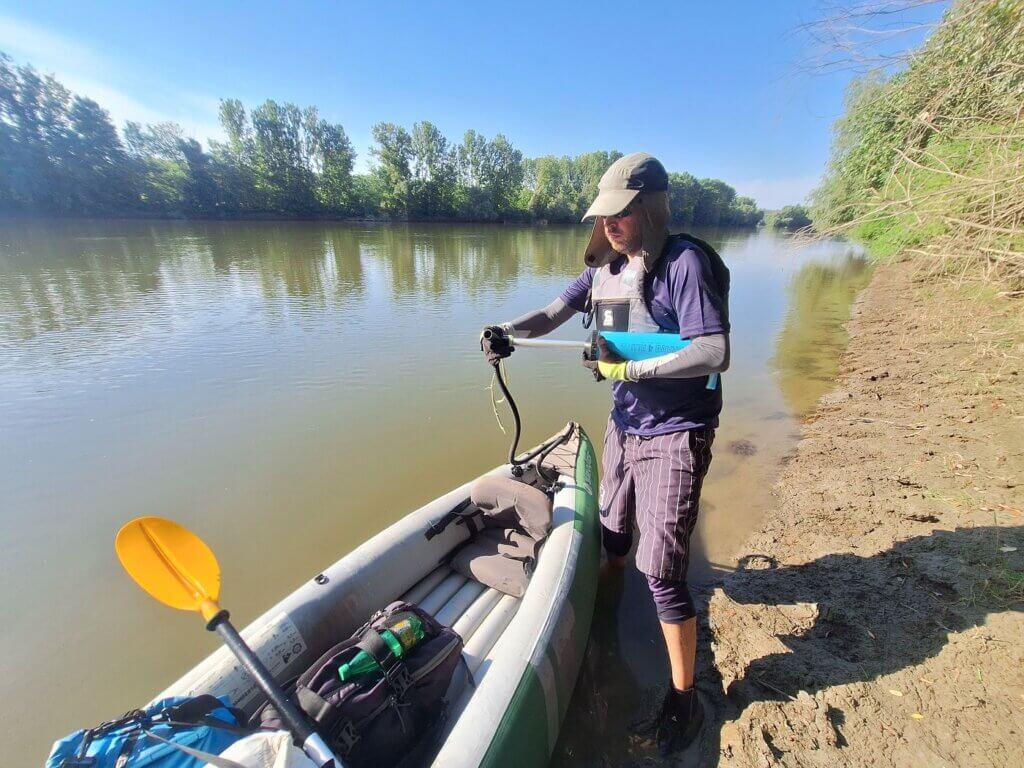 08 32 unnamed Danube River island near Seimeni Romania landing spot Jonas pumping up inflatable kayak Zucchini leak mud