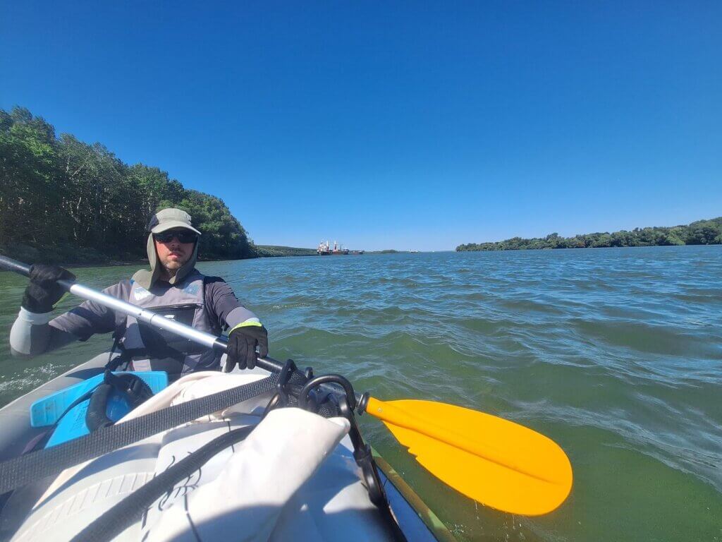 Jonas kayaking Danube River last bit before the Delta anchorage site big maritime cargo ships bulk carriers