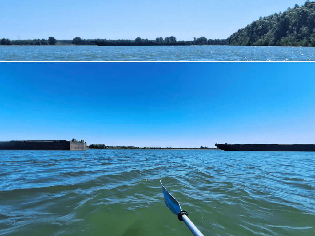 paddling between barges at anchor Danube River kayaking to the Black Sea Romania Tulcea