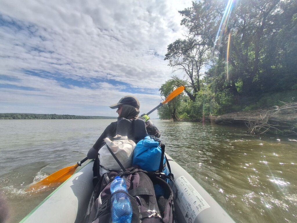 Jonas sitting in the front of Zucchini paddling Danube River kayak trim balance headwind strategy