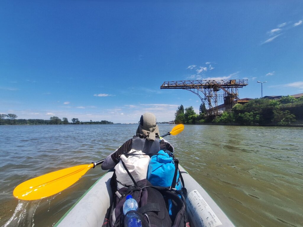 Jonas kayaking in the front seat Zucchini port of Smederevo Serbia crane