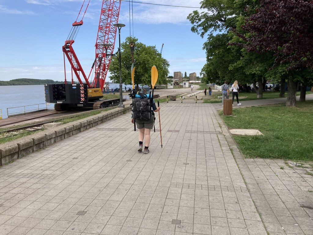 Iris Veldwijk walking with Zucchini kayak in a backpack Smederevo Serbia waterfront