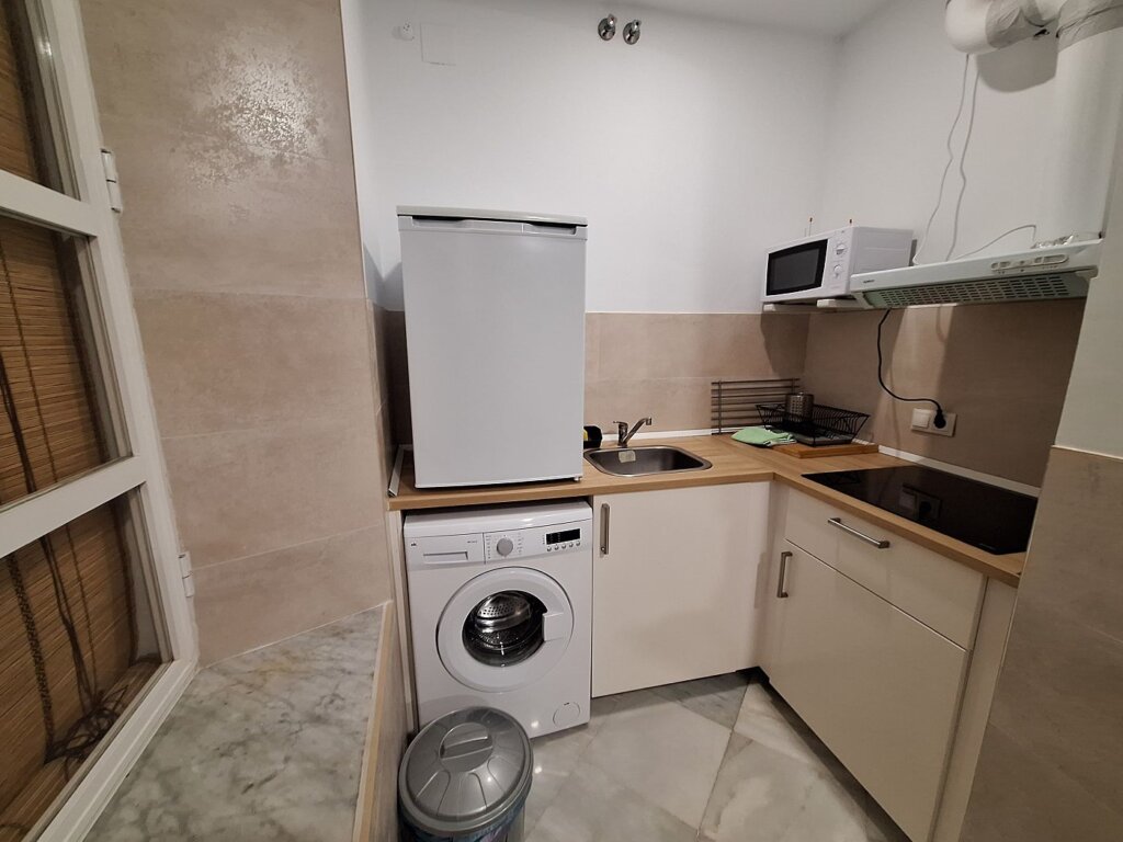 Sevilla couple's apartment Spain kitchen washing machine stove microwave fridge