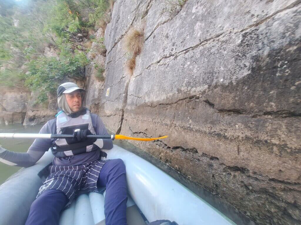 Jonas parallel inflatable kayak touching canyon wall Cazanele Mari Veliki Kazan Klisura Gorge Great Kazan Gorge Iron Gates Romania Serbia border