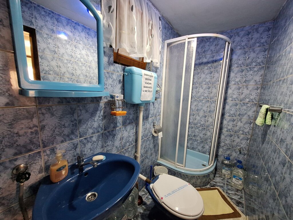 Bathroom Aleksandar Apartments and rooms Golubac shower cabin sink washing machine accommodation in Serbia