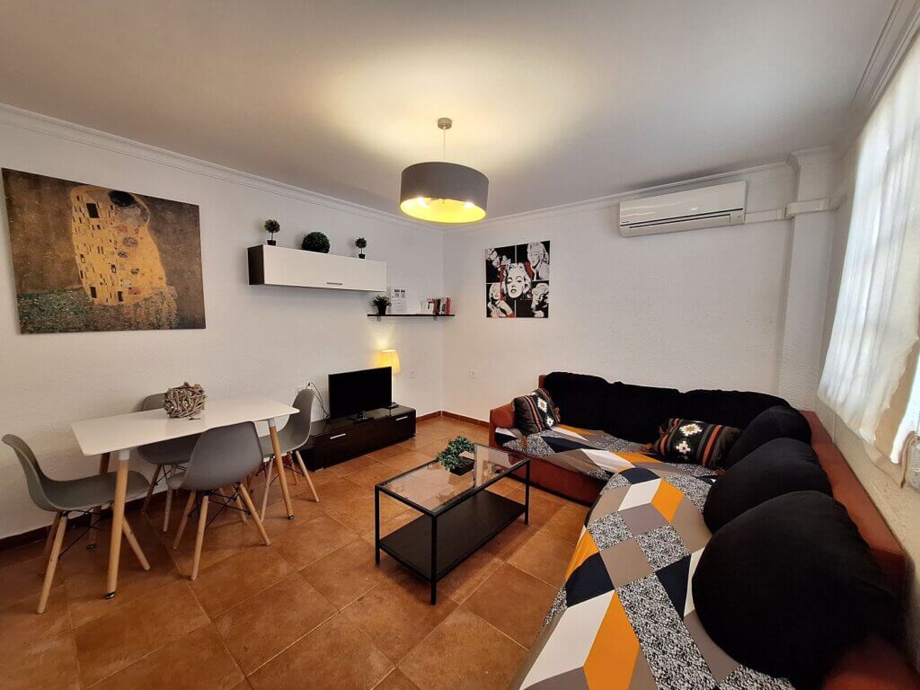 living room accommodation in Spain digital nomad desk table couch tv malaga andalusia