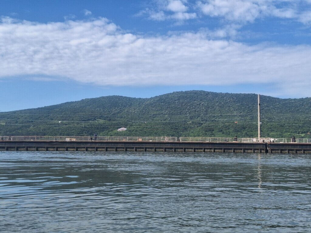 Tito Sign Iron Gate I dam lock Derdap I Portile de Fier I shipping canal Danube River Romania Serbia mooring area kayak pov