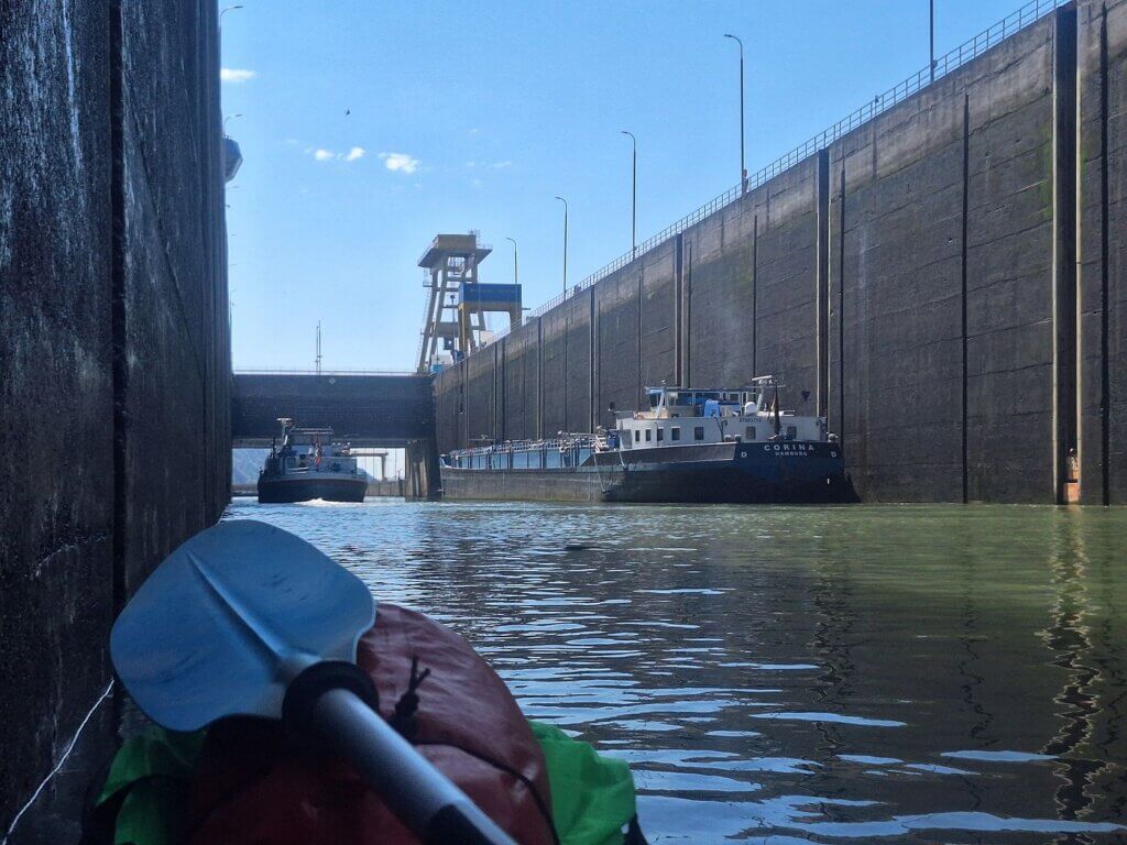 Serbian ship and German Corina Hamburg departing Iron Gate I lock Danube River Romanian side kayaking to the Black Sea