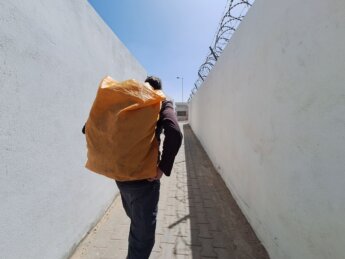 Guerguerat border pedestrian crossing wall barbed wire Mauritania through the berm Morocco Western Sahara wall