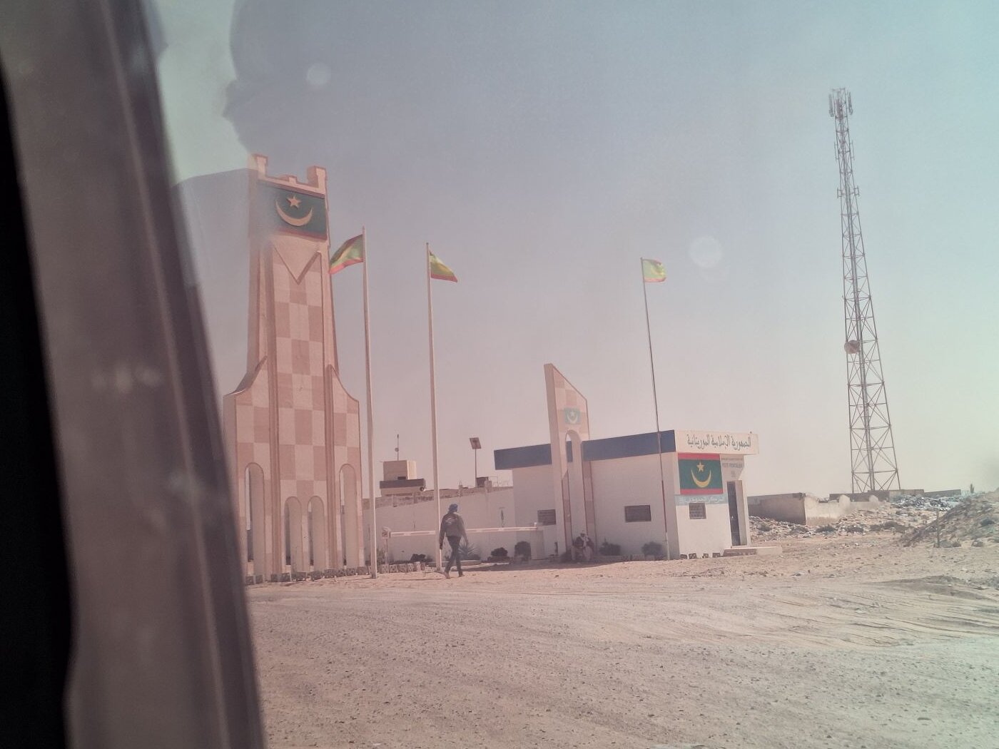 arriving at the Mauritanian border from no man's land end of the Morocco Western Sahara wall berm travel backpacking immigration stamp