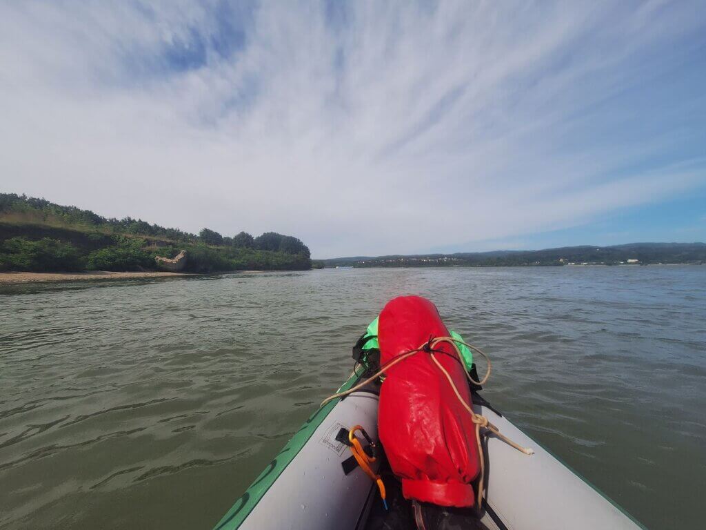 WWII bunkers on the Romanian side of the Danube river bend cargo ship near Iron Gate II to Comoara Istrului