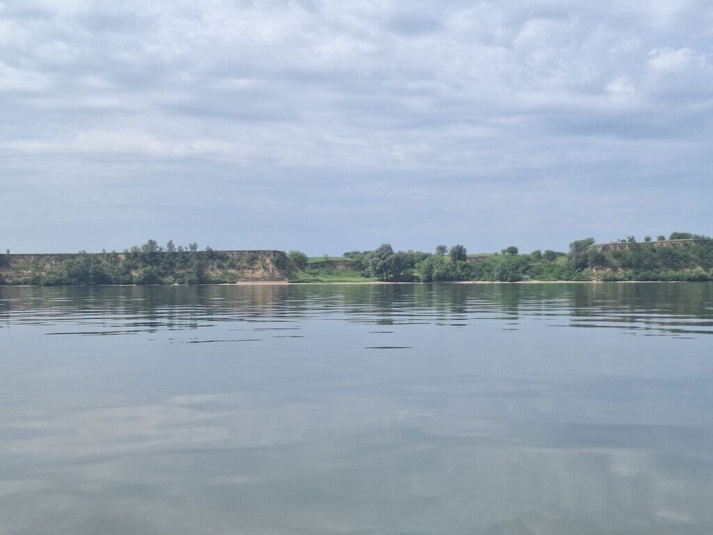 50 meter high loess cliffs Romanian side of the Danube near Tismana farmland river