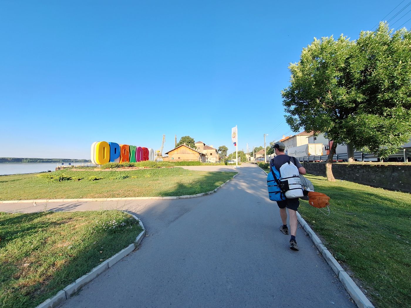 end of 60 kilometer kayak day Lom to Oryahovo Bulgaria Jonas walking dry bags to hotel Danube river kayaking