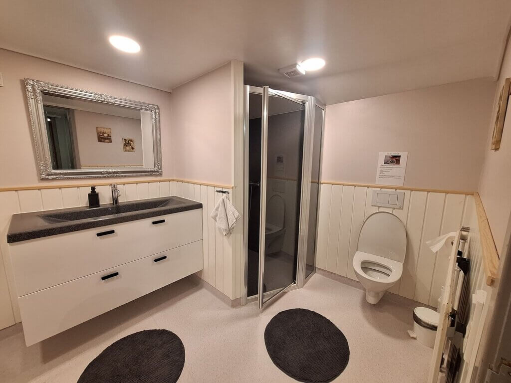 accommodation in the Faroe Islands Midvágur Vágar island airport apartment bathroom digital nomad travel North Atlantic Ocean sink shower toilet