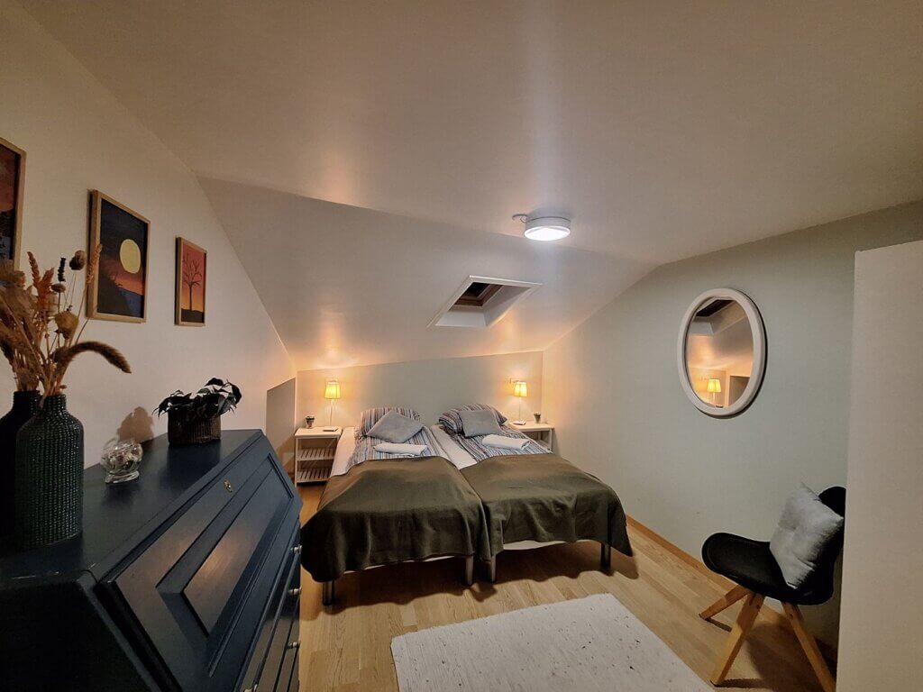first bedroom apartment Midvagur Miðvágur double bed nightstands accommodation in the Faroe Islands couple group travel
