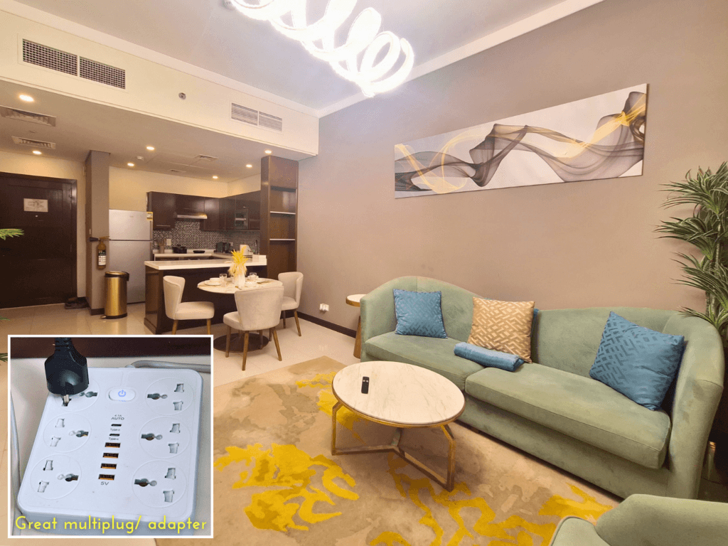 living room Manama Bahrain Al Fateh serviced apartment Airbnb couch TV multiplug adapter international chargers charging USB universal