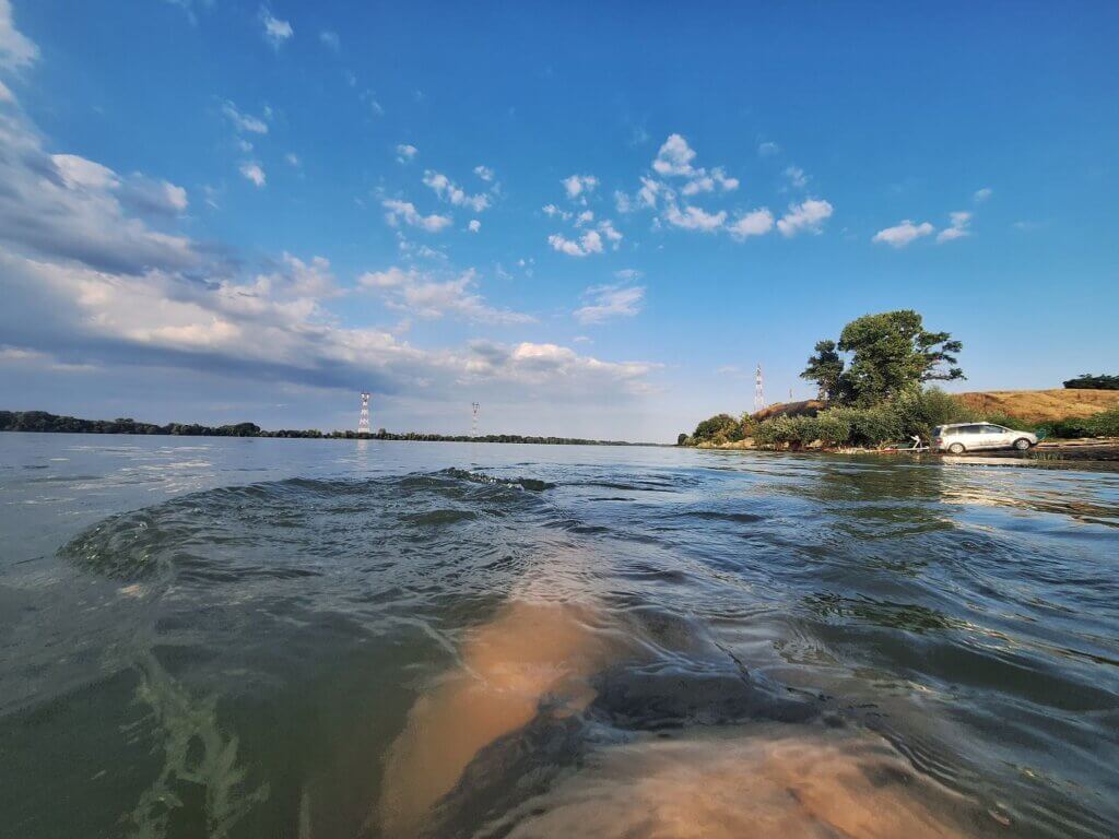 Iris swimming Danube River Isaccea Romania border area Ukraine powerlines sunset