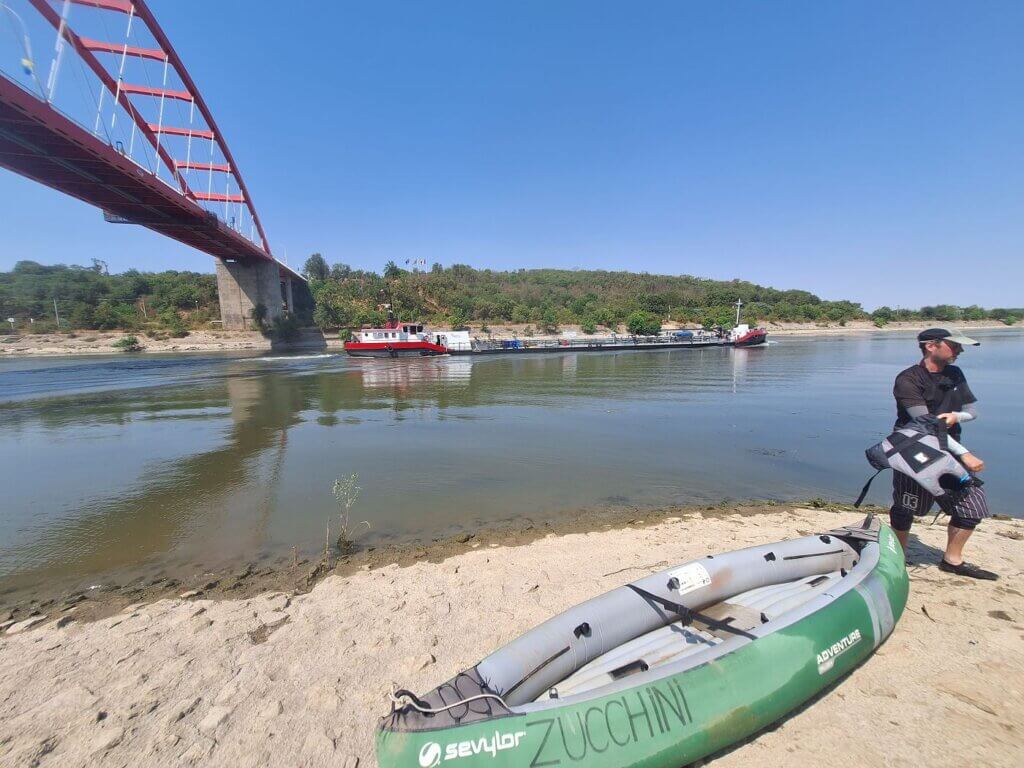 Jonas with Zucchini the inflatable kayak in the Danube–Black Sea Canal Cernavoda Constanta Dobruja Romania shipping cargo